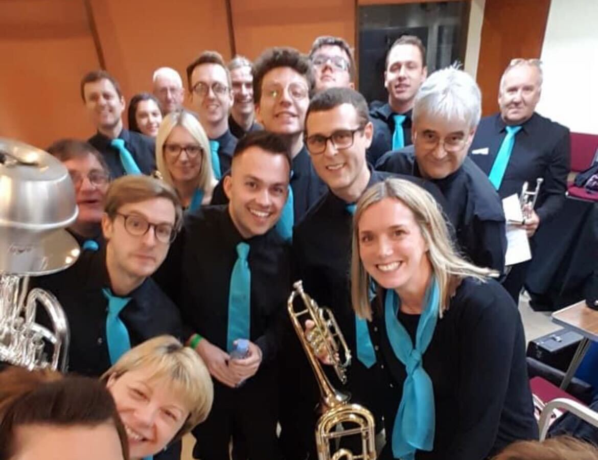 Band members smiling backstage