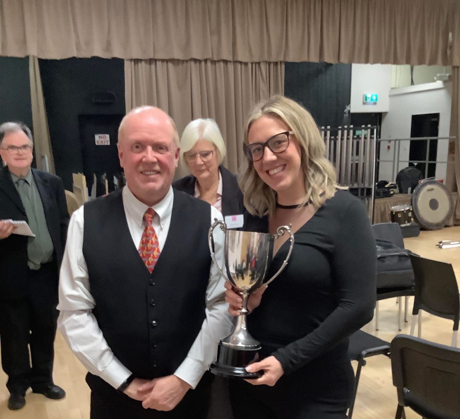 Band member receiving a trophy